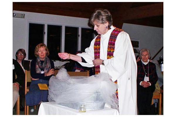 ECDNE Priest Jean Marchant at a Baptism
